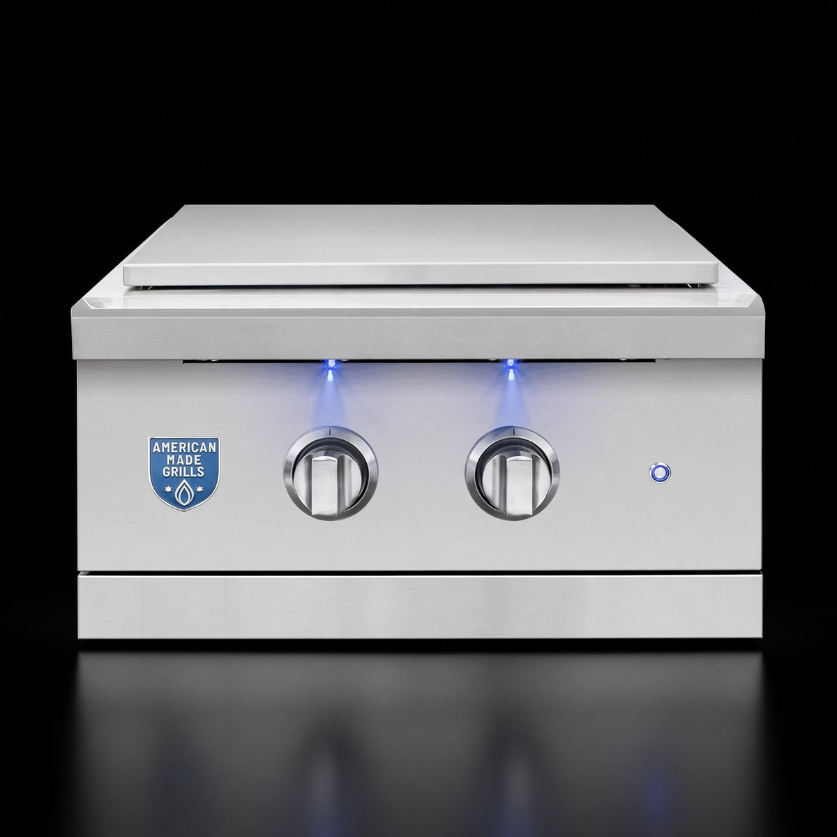 Atlas Power Burner side burner, front view with closed stainless steel lid and illuminated control knobs