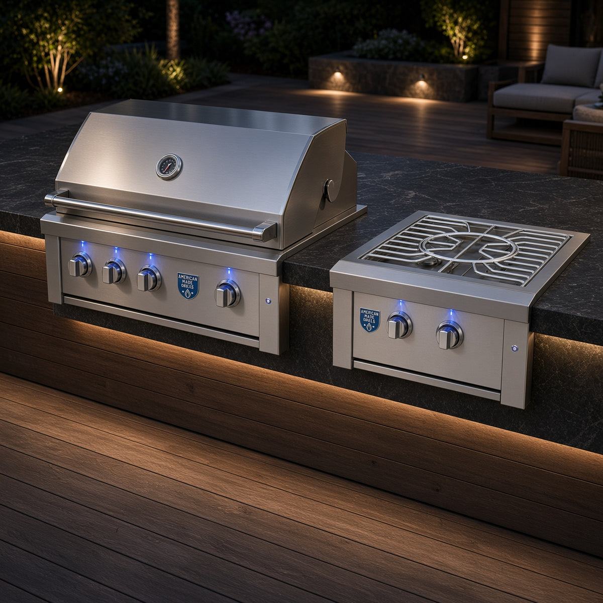 Estate Power Burner installed alongside a matching American Made Grills built-in grill on a wood deck outdoor kitchen at dusk