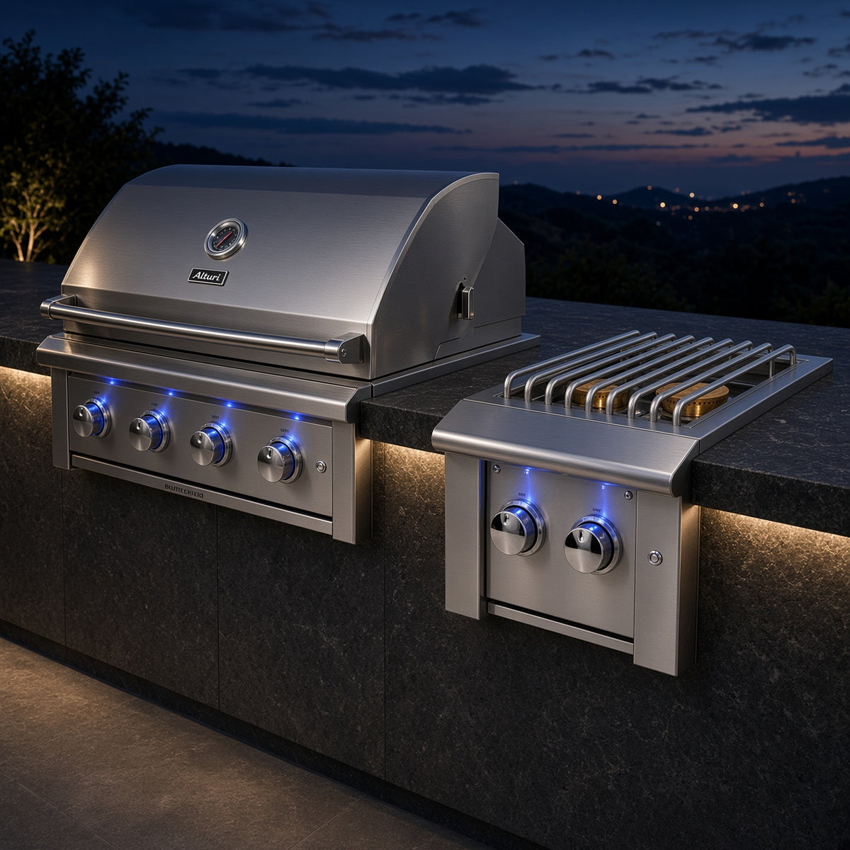Atlas Power Burner installed alongside a matching American Made Grills built-in grill in an outdoor kitchen at night, illuminated knobs visible on both units
